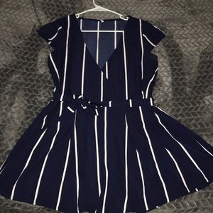This a navy blue and white striped romper.